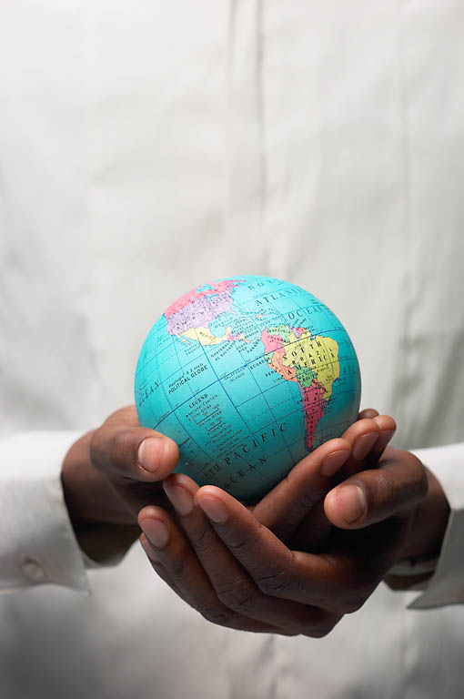 Hands holding a small globe