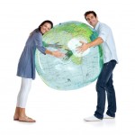 Couple hugging a large transparent globe